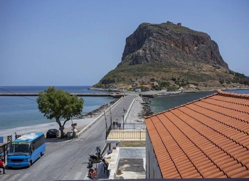 Aktaion Hotel in Monemvasia with a sea view, road to the rocky island, and terracotta rooftops