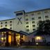 Golden Tulip Kumasi City hotel exterior in Kumasi with illuminated entrance at dusk