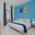 Tra i Monti in Tramonti: bright guest room with blue accent wall, double bed, desk, and air conditioner