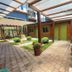 Pousada Charm Canela in Canela, covered courtyard walkway with potted shrubs and wooden pergola