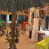 Hotel San Julio in Celestún outdoor shaded seating area with colorful tables and stools