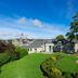 Mercure Aberdeen Ardoe House in Aberdeen with manicured lawns, curved garden path and historic building