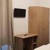 Etna Hotel & Ristorante Veitshöchheim room with bed, wardrobe, desk and wall-mounted TV