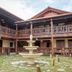 Hacienda el Jibarito in San Sebastián courtyard with stone fountain and wooden balconies