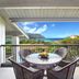 Hanalei Bay Resort in Princeville balcony with table, chairs and ocean view over lush landscaping