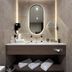 Hotel Gladbeck van der Valk bathroom vanity with oval mirror, sink, towels, and wall-mounted hair dryer in Gladbeck