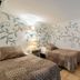 Agroturismo Ca Sa Vilda Marge room in Sant Joan de Labritja with two single beds and vine wall mural