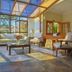 Hotel Le Renard in Campos do Jordão: sunlit lounge with glass ceiling, sofa, armchairs and coffee table