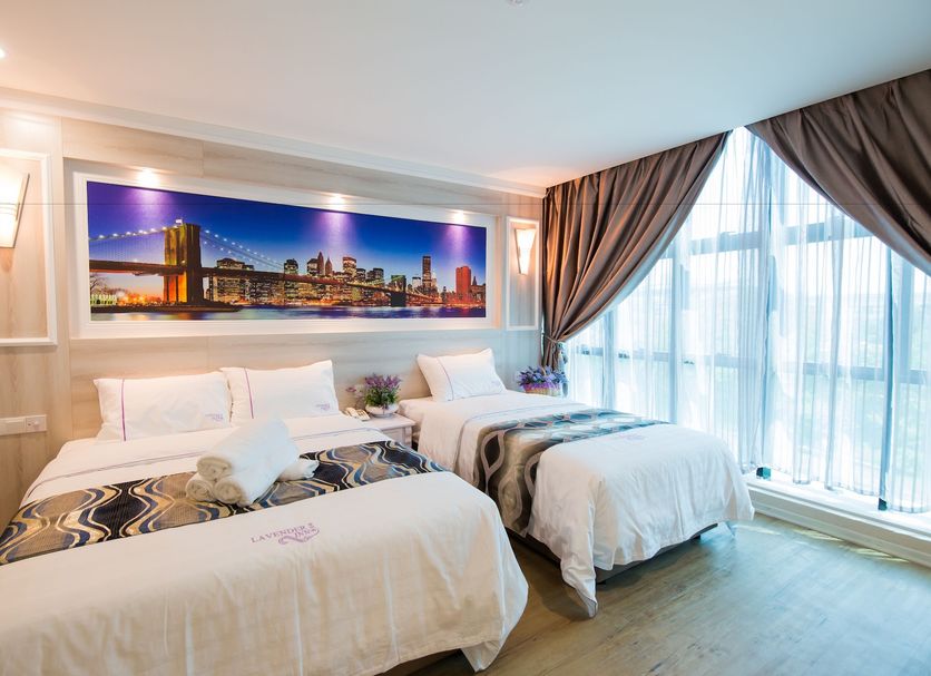 Lavender Inn Usj in Subang Jaya guest room with twin beds, city wall art, and large window drapes