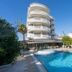 Romance Beach Hotel in Marmaris with outdoor pool and white curved balconies under blue sky