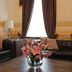Boutique Hotel Argo in Kutaisi lounge with black leather sofas, coffee table and flower vase