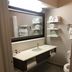 Baymont by Wyndham Laurel bathroom with vanity, mirror, towel shelves and toilet