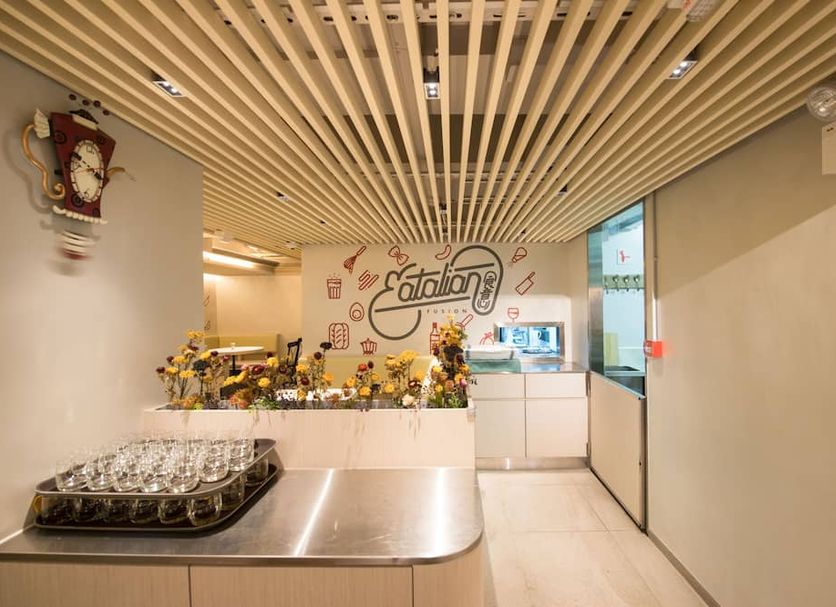 Metroplace Boutique Hong Kong lobby with buffet station, wall mural, and wood slat ceiling