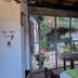 La Teresita Hotel Boutique in Salta, patio dining area with table, chairs and garden view through gate