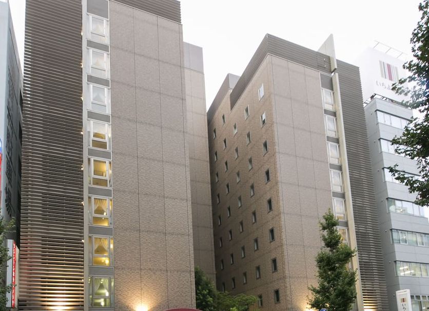 Nagoya Sakae Washington Hotel Plaza in Nagoya, exterior of tall beige hotel towers at dusk