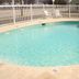 Best Budget Inn - Abilene outdoor pool with white fence and lounge chairs in Abilene