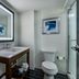 Four Points by Sheraton Brunswick bathroom with vanity, lit mirror, toilet and glass shower