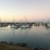 Island Views in Airlie Beach overlooking a calm marina with yachts at sunset