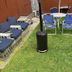 The Macaw Guesthouse, New York outdoor patio with blue chairs, table, grill and lounge seating