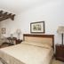 Vettonia in Ávila guest room with bed, exposed wooden beams, seating area and window