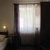 Hotel Am Markt in Eckartsberga guest room with single bed, bedside lamp and window with sheer curtains