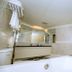 Guide Hotel Taipei Xinyi bathroom with bathtub, glass shower screen and large mirror in Taipei City