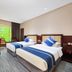 Kaisheng Xingfeng International Air in Beijing: twin beds, desk, and large window with green view