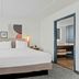 Spark by Hilton Mechanicsburg Harrisburg West guest room with king bed and adjoining bathroom doorway
