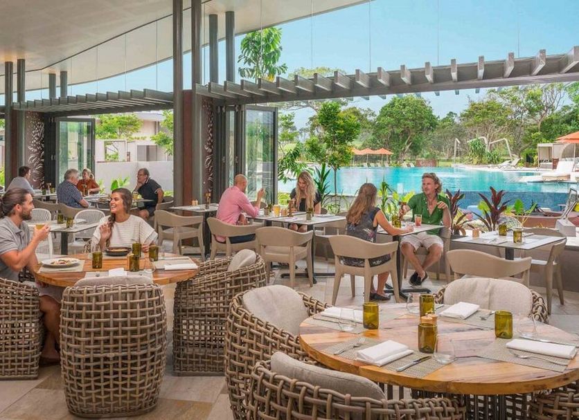 Elements of Byron, Byron Bay: open-air poolside restaurant with guests dining by the resort pool