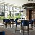 The Westin Reston Heights in Reston lounge with high tables, blue chairs, and large windows