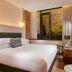 The Chancery Hotel Dublin guest room with king bed and large window to brick courtyard greenery