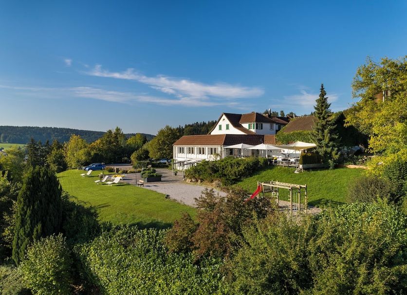 Hotel Wassberg in Maur with a hillside terrace, lawn, and scenic valley views