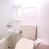 Lodge Koropokkuru in Niseko bathroom with tub, sink, toilet, and wall-mounted shower