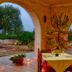La Piana degli Ulivi in Ostuni: covered terrace dining table with countryside and distant town views