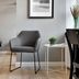 Kragsbjerggaard in Odense: modern guest room with gray chair, side table, bed, and framed wall art