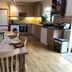 Robeanne House in Beverley kitchen-dining area with wooden table, chairs, and modern appliances