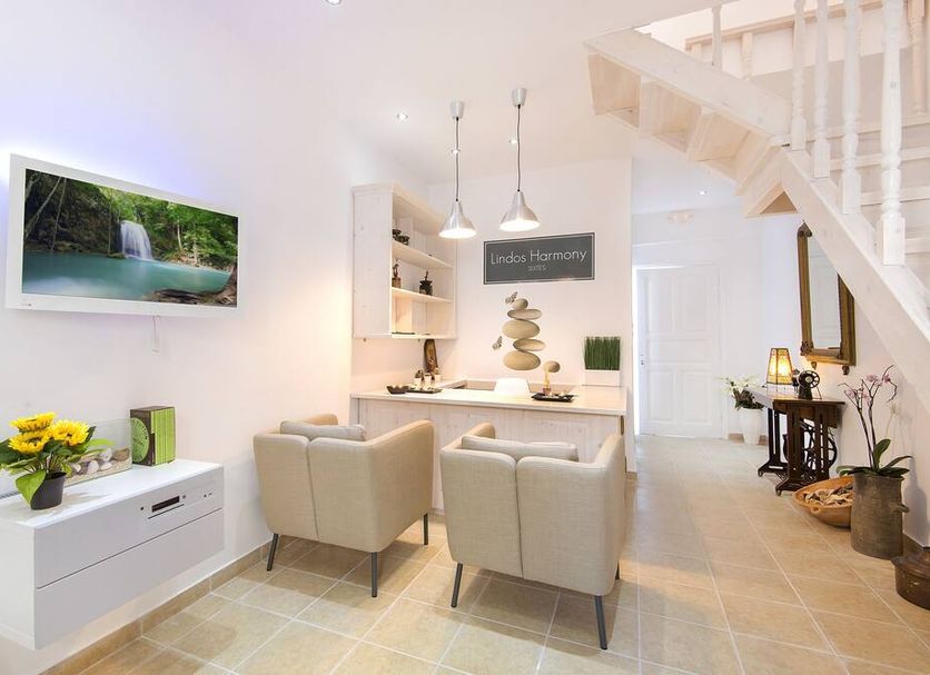 Lindos Harmony Suites in Lindos: bright suite lounge with dining nook and staircase