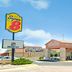 Super 8 by Wyndham Belen NM exterior with sign, covered entrance, and blue sky in Belen