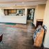 Lobby area at Super 8 by Wyndham Belen NM in Belen with front desk, seating, and brochure rack