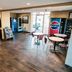Super 8 by Wyndham Belen NM lobby with vending machines and small café tables in Belen