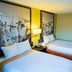Super 8 by Wyndham Belen NM room with two beds, framed wall art, and bedside lamp in Belen