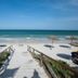 Nour Palace Resort And Thalasso Mahdia beach access with steps to sandy shore and sea umbrellas