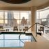 Indoor pool at Fairmont Austin Gold Experience with skyline views in Austin