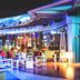 Millennium Al Rawdah Hotel in Abu Dhabi rooftop lounge with colorful seating and glass walls at night