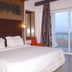 Jamindars Palace Puri room with king bed and sliding glass doors opening to ocean view balcony
