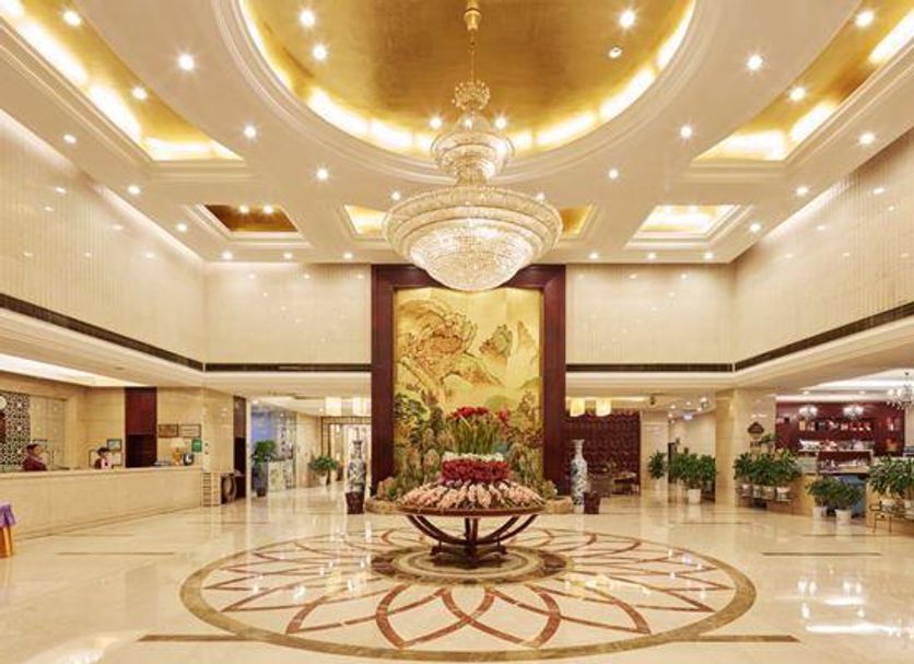Zhucheng Huaxi Grand Hotel lobby in Rizhao with chandelier, marble floor and ornate ceiling