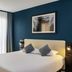 Aparthotel Adagio Monaco Palais Joséphine, Beausoleil: modern guest room with king bed and blue accent wall