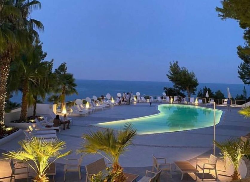 Ah Premium Baia Dei Faraglioni, Mattinata: illuminated outdoor pool terrace overlooking the sea