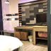Guest Motel-Zhubei in Zhubei City room with bed, desk, TV, and frosted glass partition