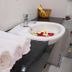 Ban Mai Hotel 66 in Phan Thiet bathroom with sink, fresh towels, and flower petals